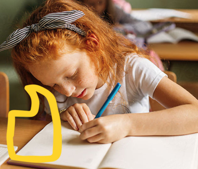 Image of a girl writing on a notebook